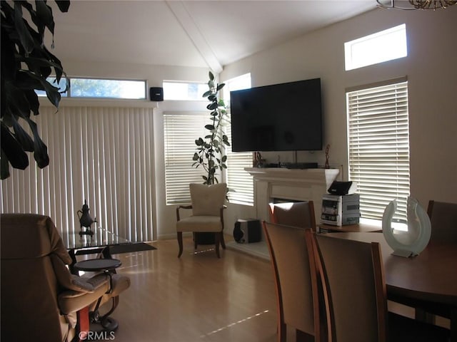 dining space featuring lofted ceiling and a fireplace