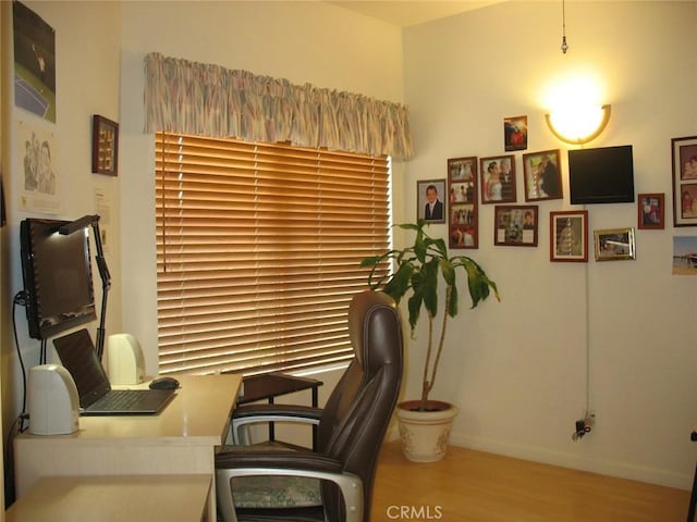 home office featuring baseboards and wood finished floors