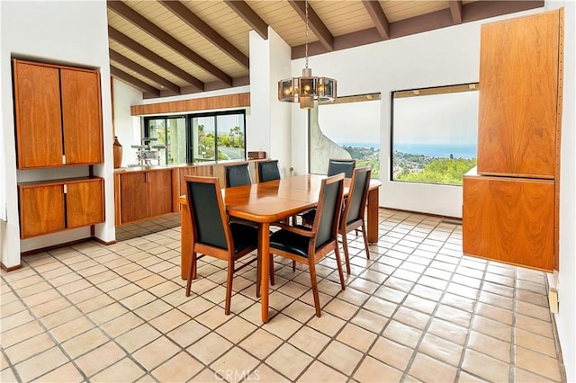 dining space with a chandelier, vaulted ceiling with beams, and wood ceiling