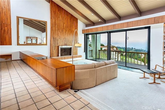 living area featuring light tile patterned floors, beam ceiling, high vaulted ceiling, and wood ceiling