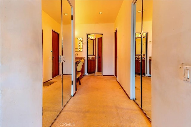 corridor with recessed lighting and light carpet