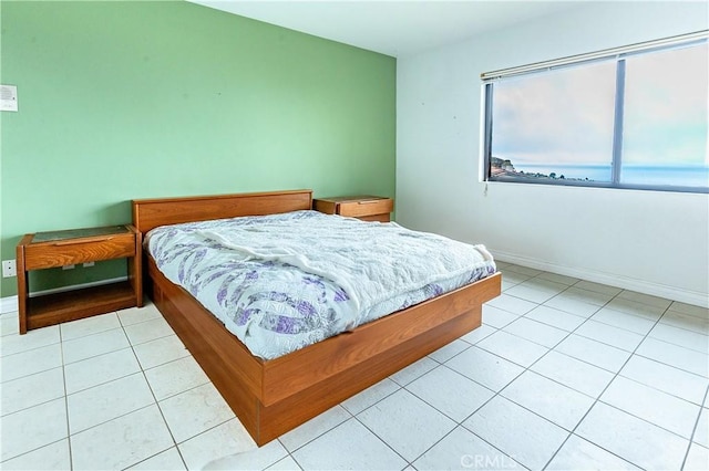 bedroom featuring baseboards and light tile patterned flooring