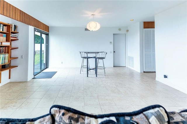 dining space with light tile patterned floors, visible vents, and baseboards