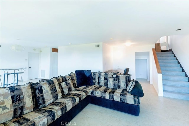 living area featuring visible vents and stairs