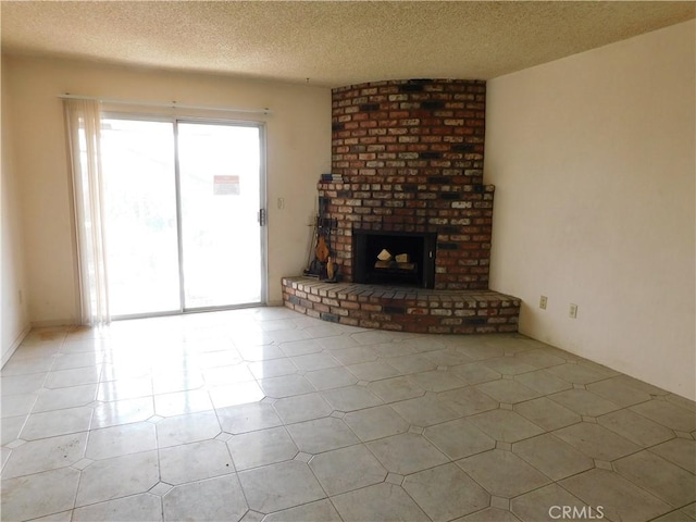 unfurnished living room with a brick fireplace and a textured ceiling