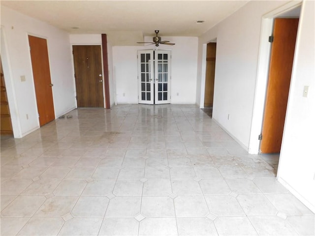 unfurnished room with visible vents, french doors, baseboards, and ceiling fan