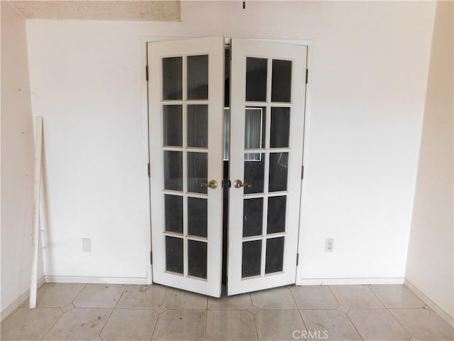 details featuring french doors and baseboards