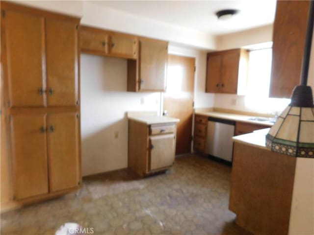 kitchen with brown cabinets, dishwasher, and light floors