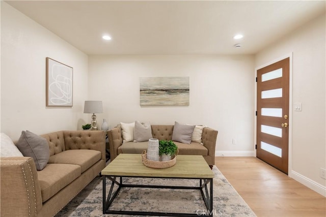 living area with recessed lighting, light wood-style flooring, and baseboards