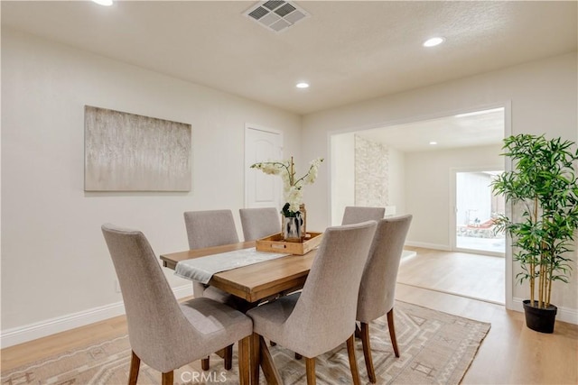 dining area featuring light wood-style flooring, recessed lighting, and visible vents