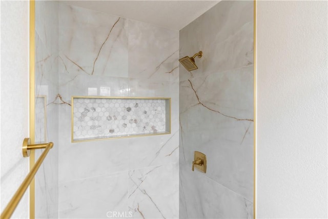 bathroom featuring a marble finish shower