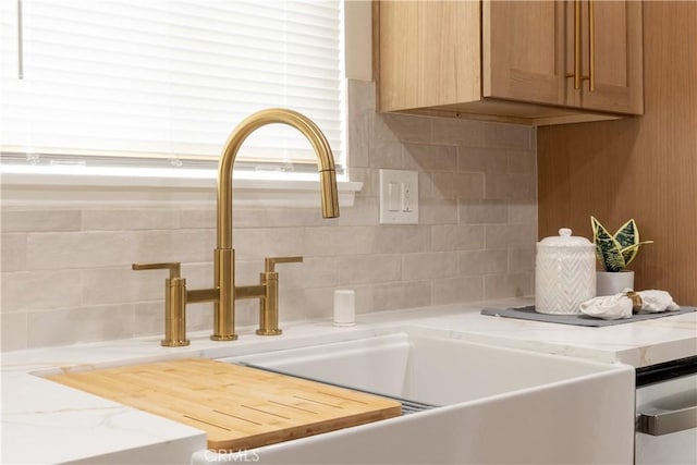 interior details featuring tasteful backsplash and a sink