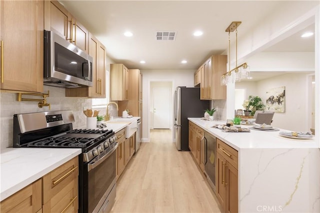 kitchen with visible vents, backsplash, light wood-type flooring, recessed lighting, and appliances with stainless steel finishes