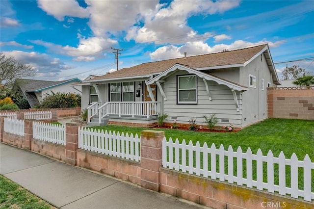 view of front of home with a fenced front yard, crawl space, covered porch, and a front lawn