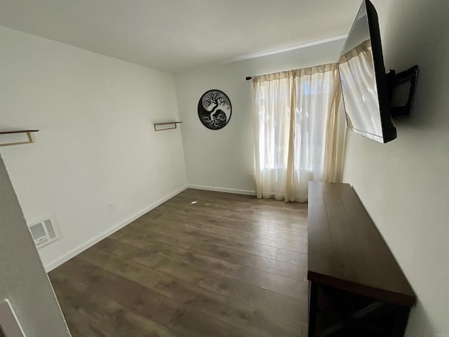 interior space with visible vents, baseboards, and wood finished floors