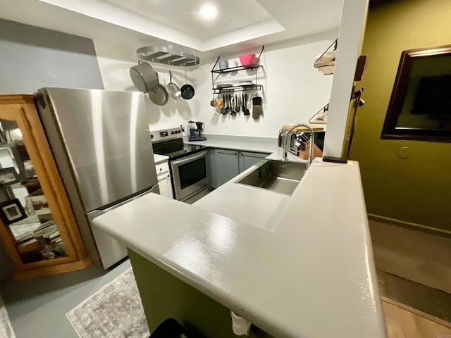 432 Edgehill Ln Unit 175, Oceanside, CA 92054 - kitchen with a tray ceiling, light countertops, appliances with stainless steel finishes, and a sink