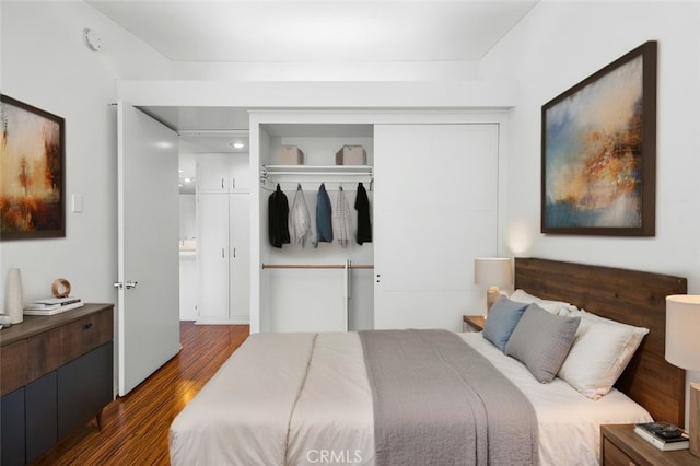 bedroom with a closet and dark wood-style flooring