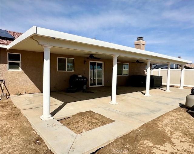 back of property featuring a patio, fence, a chimney, and ceiling fan