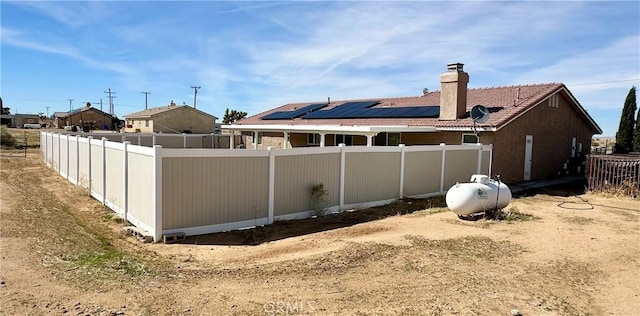 exterior space with a chimney and fence