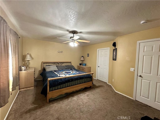 carpeted bedroom featuring baseboards, a textured ceiling, and ceiling fan