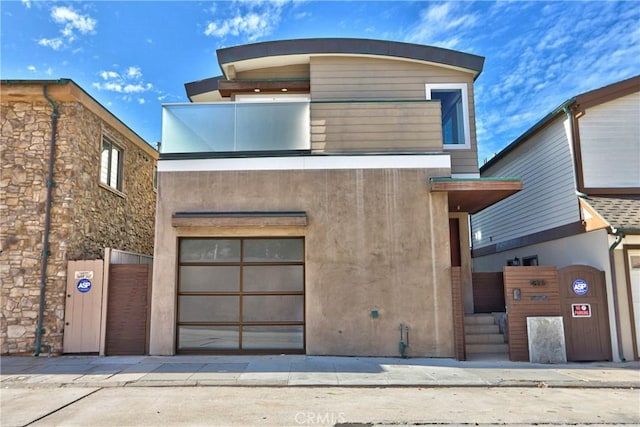 contemporary house with stucco siding and a garage