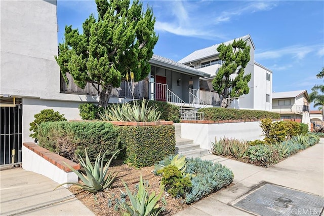 view of front of home featuring stairway and stucco siding