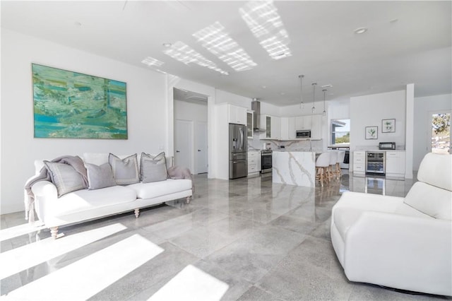 living area featuring visible vents and beverage cooler