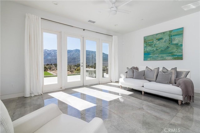 living area featuring visible vents, a mountain view, a healthy amount of sunlight, and french doors