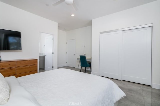 bedroom with baseboards, recessed lighting, ceiling fan, a closet, and ensuite bathroom