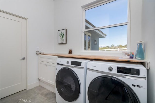 laundry room featuring washer and clothes dryer and cabinet space