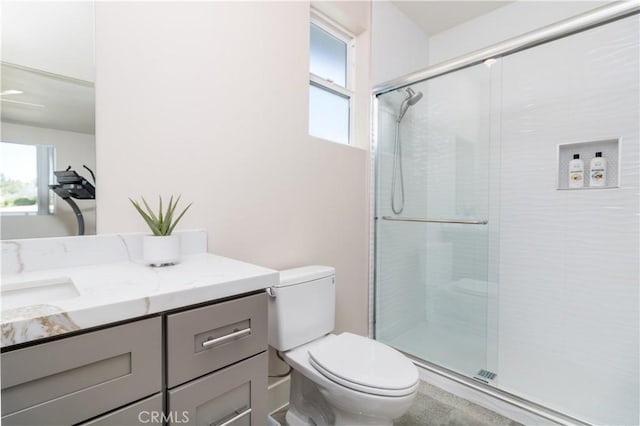 bathroom with vanity, toilet, and an enclosed shower