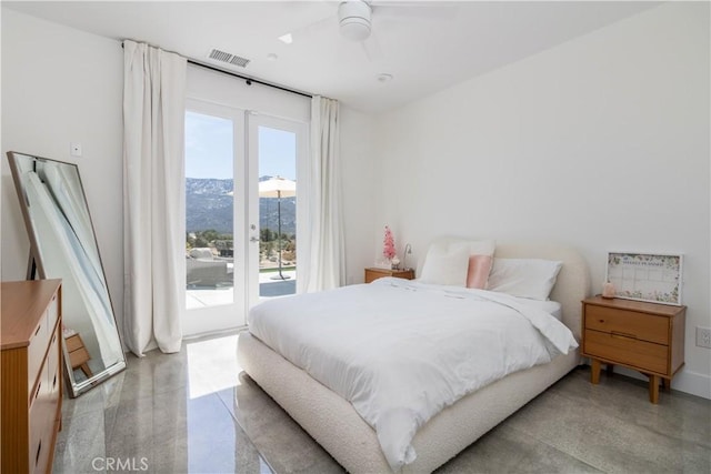 bedroom with ceiling fan, visible vents, access to exterior, and a mountain view