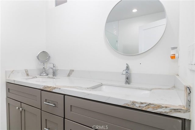 full bath featuring a sink and double vanity