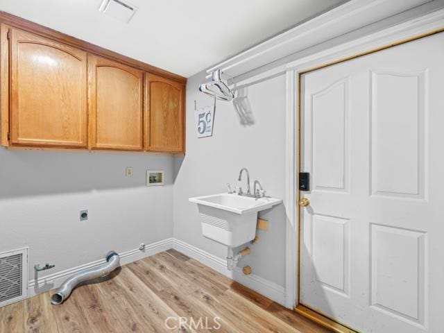 washroom with hookup for a gas dryer, visible vents, hookup for a washing machine, and light wood finished floors