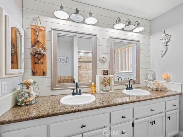 full bath featuring a sink and double vanity