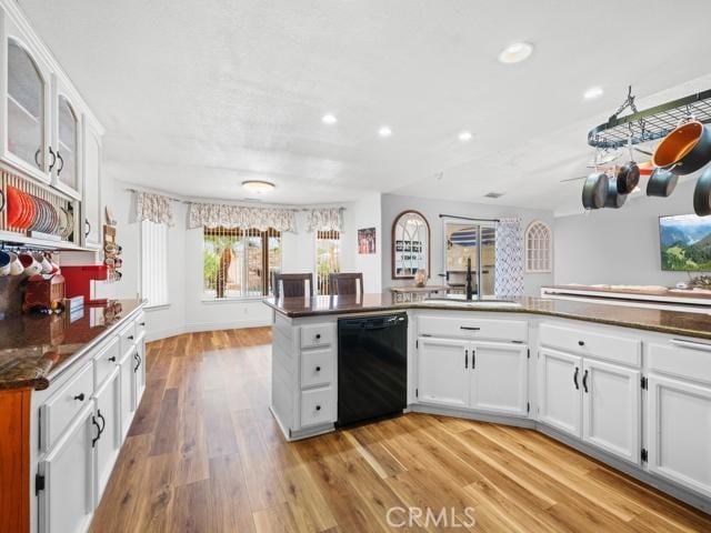 kitchen featuring recessed lighting, a sink, white cabinets, dishwasher, and light wood-type flooring