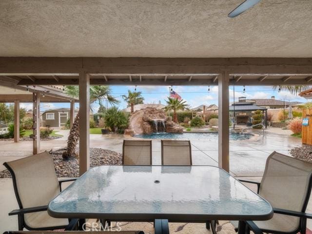 view of patio with a gazebo, outdoor dining area, and an outdoor structure