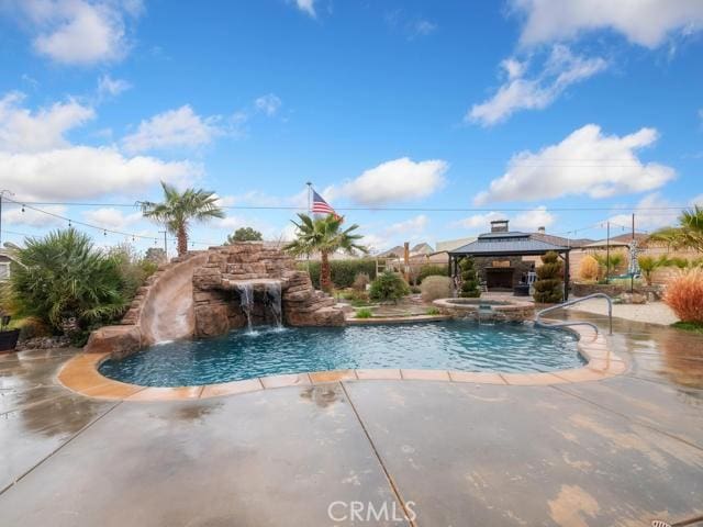 view of swimming pool featuring a gazebo, a pool with connected hot tub, and a patio