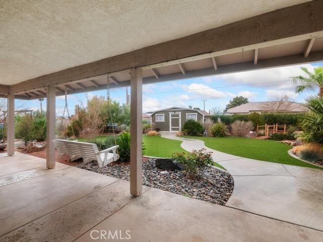 view of patio featuring an outbuilding