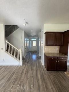 hall featuring baseboards and wood finished floors