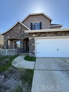 traditional-style home with stucco siding, concrete driveway, and an attached garage