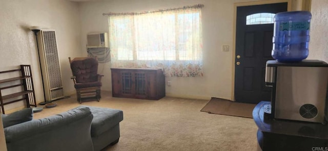 carpeted living area with baseboards and a heating unit