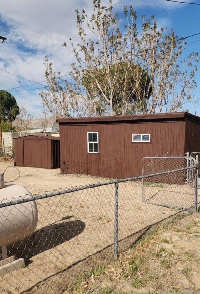 view of outbuilding with an outdoor structure and fence