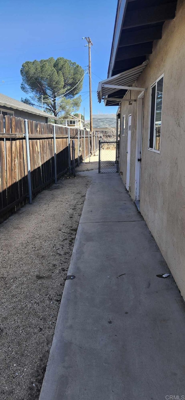 view of home's exterior featuring fence and stucco siding