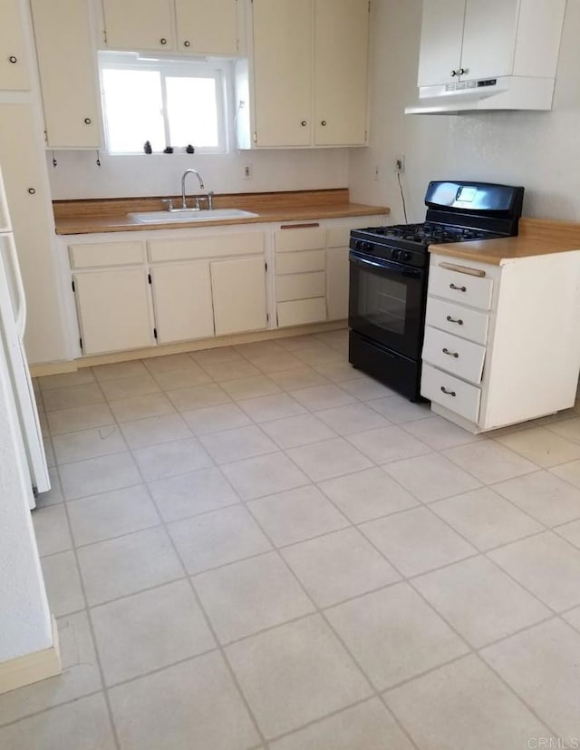 kitchen featuring light countertops, under cabinet range hood, black range with gas cooktop, and a sink