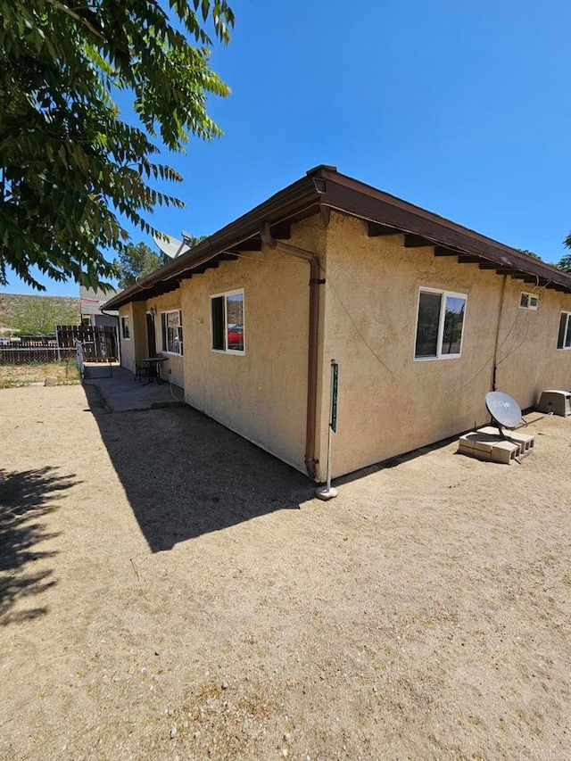 44600 Brawley Ave, Jacumba, CA 91934 - rear view of house featuring stucco siding and a patio area