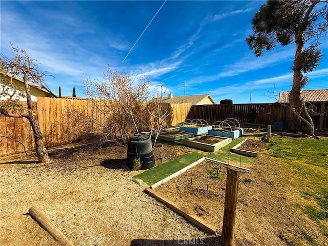 view of yard with a fenced backyard and a garden