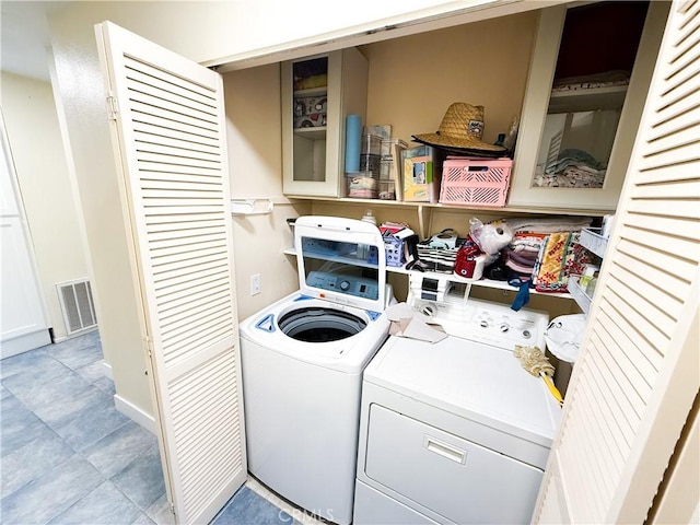 laundry area featuring laundry area, visible vents, and washing machine and clothes dryer