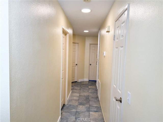 hallway featuring baseboards