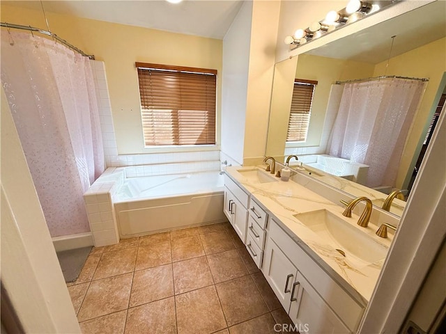 bathroom featuring a sink, a garden tub, and tile patterned floors